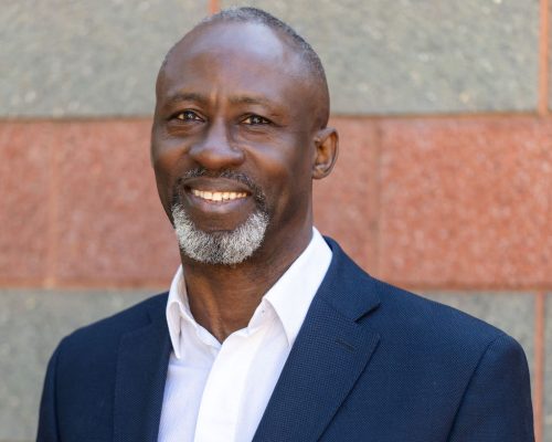 Smiling senior Black man in suit jacket and white shirt